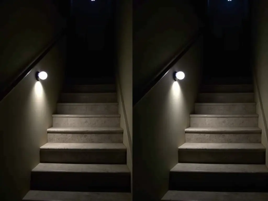 Motion-activated LED light mounted on stairwell wall illuminating dark concrete stairs for safety and accessibility.